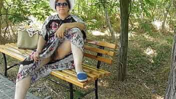 Chubby wife in transparent dress in public park upskirt