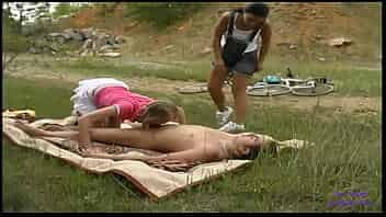 Two friends on bicycles meet a naked man sunbathing ...